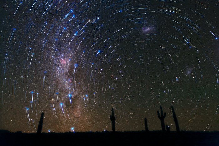 Rastos de estrelas por cima dos cactos no deserto do Atacama